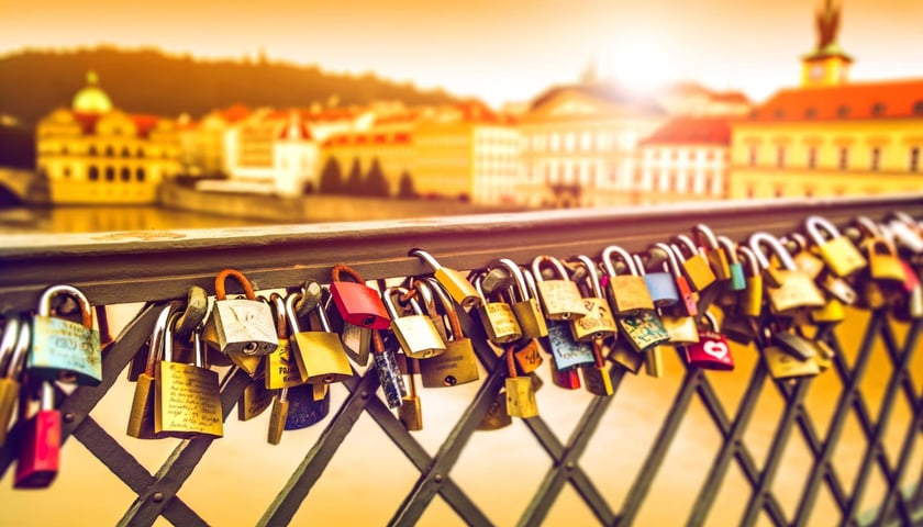 An image of love locks attached to a bridge in Europe, with each lock representing a unique love story